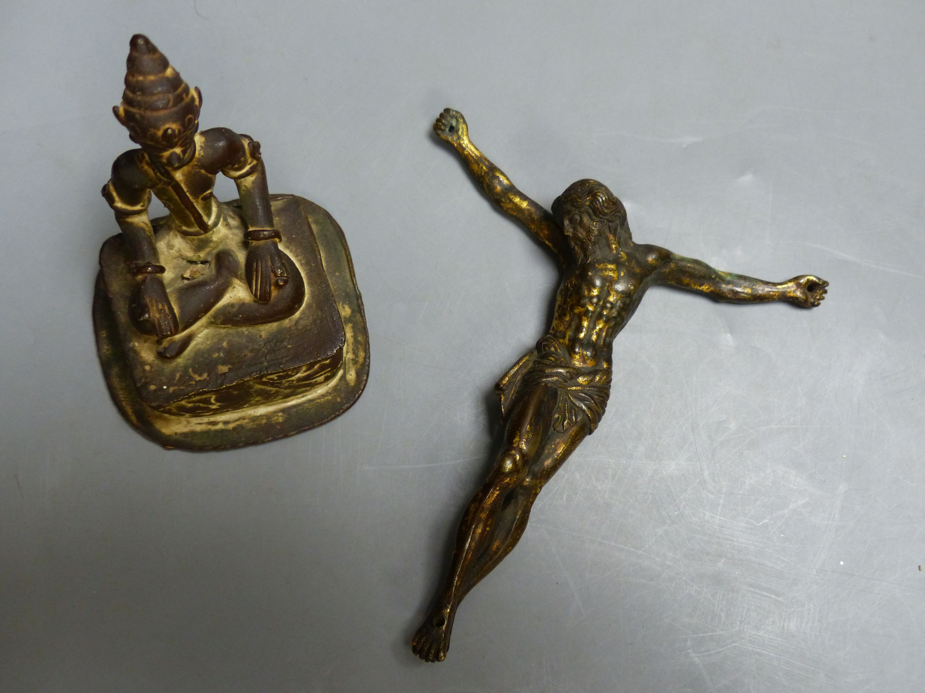 An Indian Buddhist figure and a gilt bronze Corpus Christi, largest 13cm